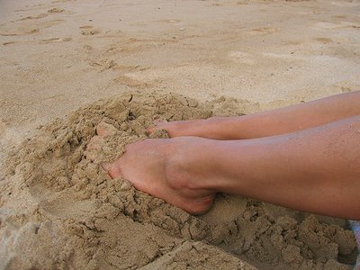 Feet in beach sand