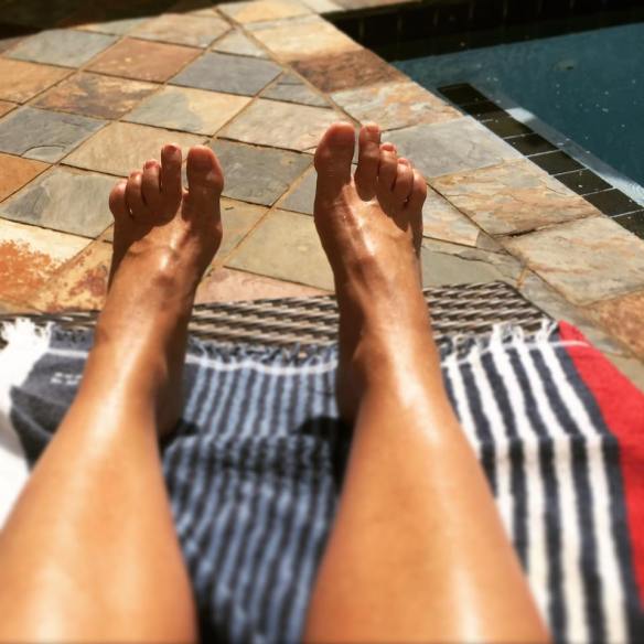 Looking down this time at my feet suntanning next to the pool