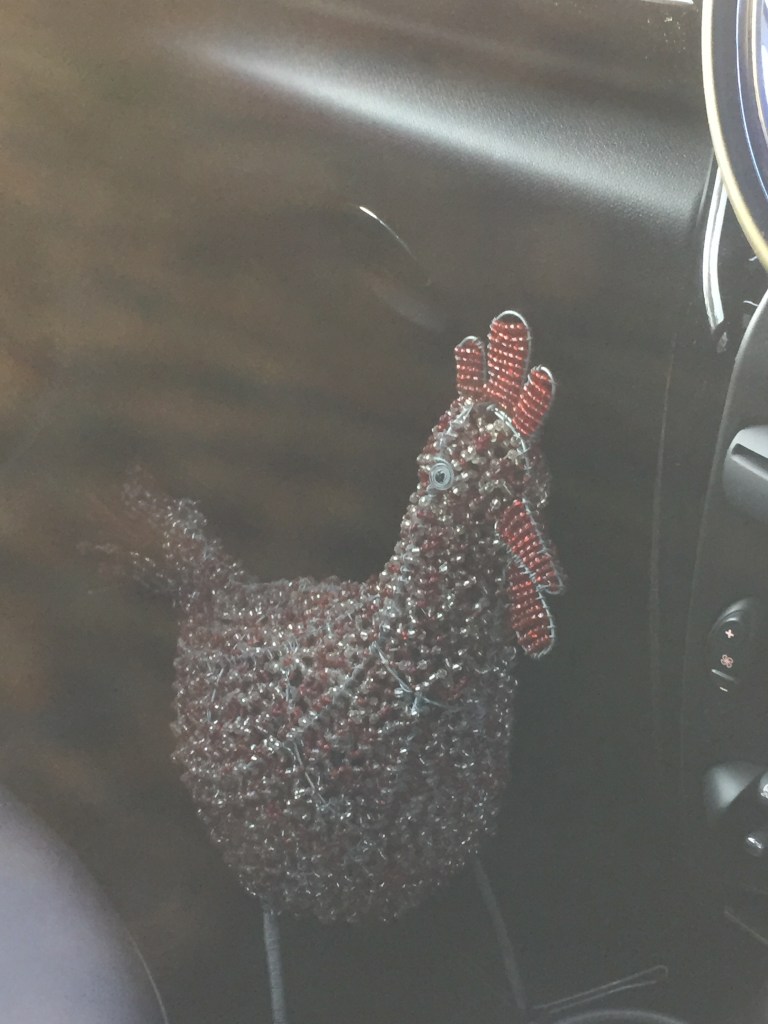 the rooster from the front seat of the car